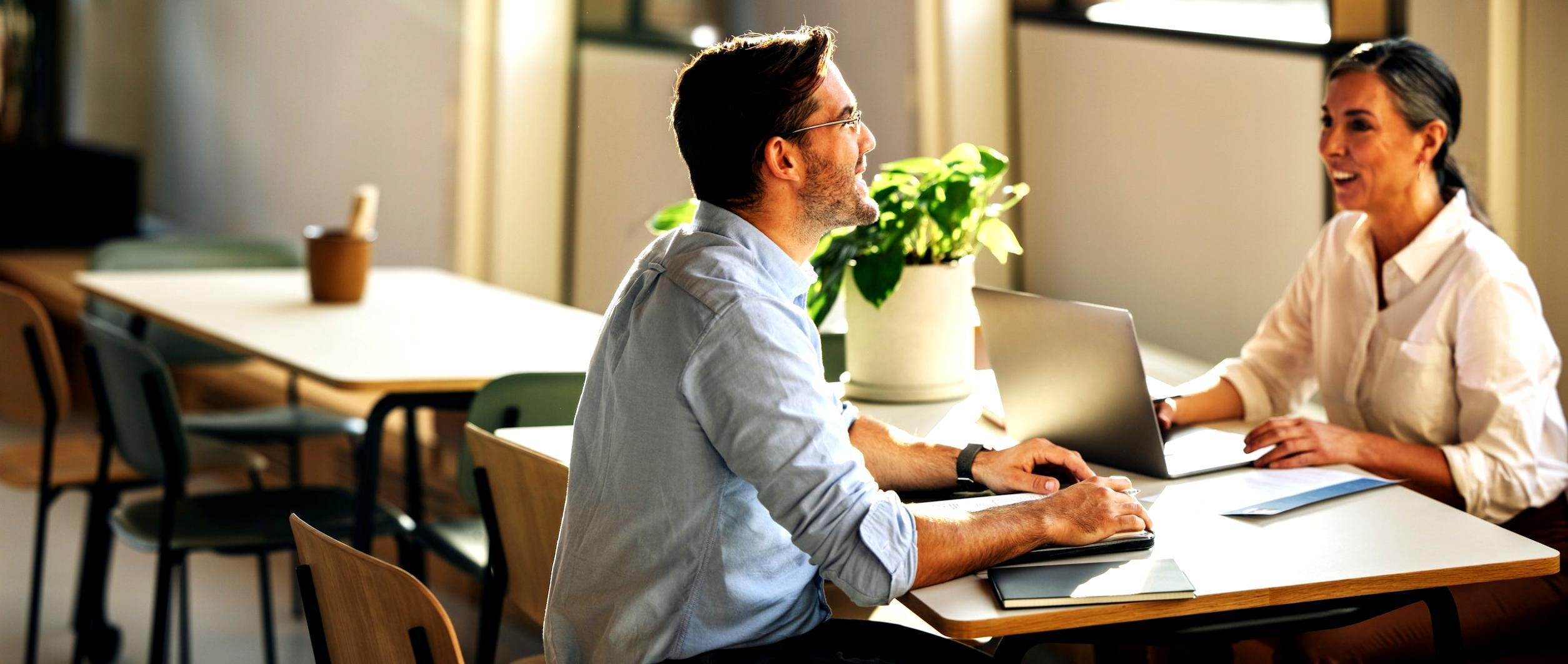 Business systems workshop with multiple stakeholders reviewing operations